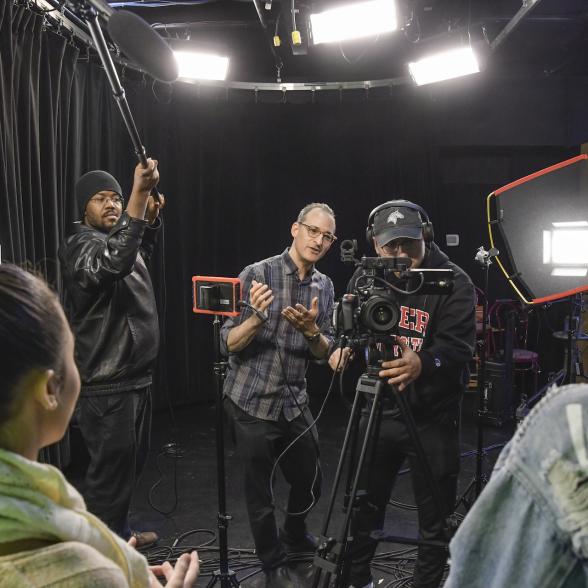 A group of students behind a camera on a film set