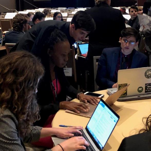 Vietnam 2018 Model UN team works on laptops
