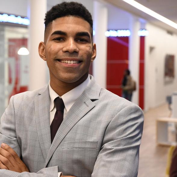 Business student with arms crossed