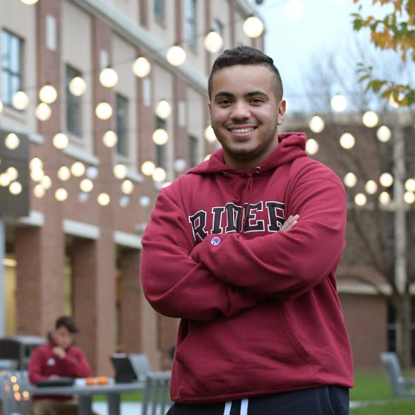 Student on Mulhare patio at Sweigart Hall