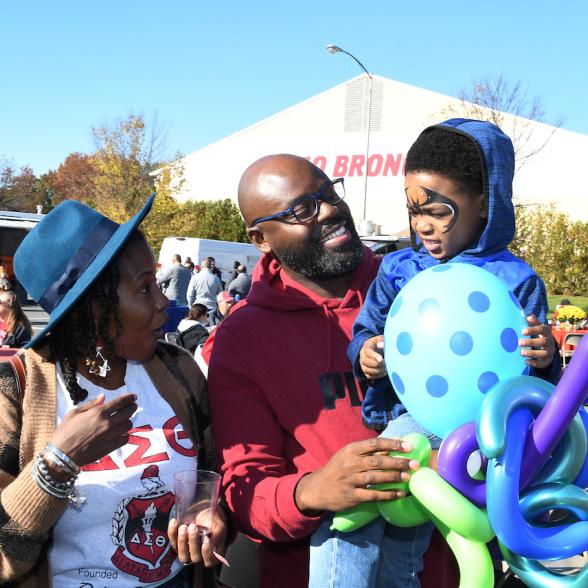 Family interacts with son in outdoor event