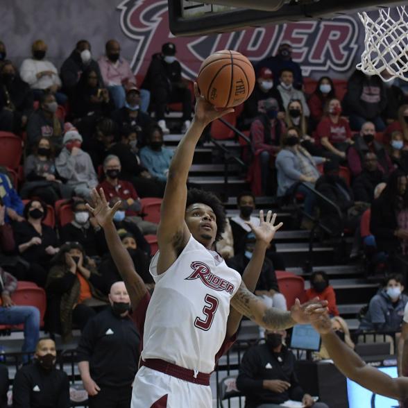 Men's basketball player goes for a layup