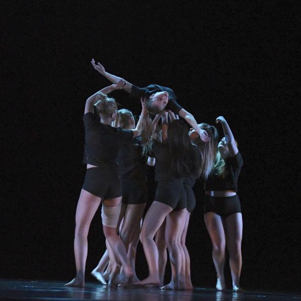 students lifting a dancer up