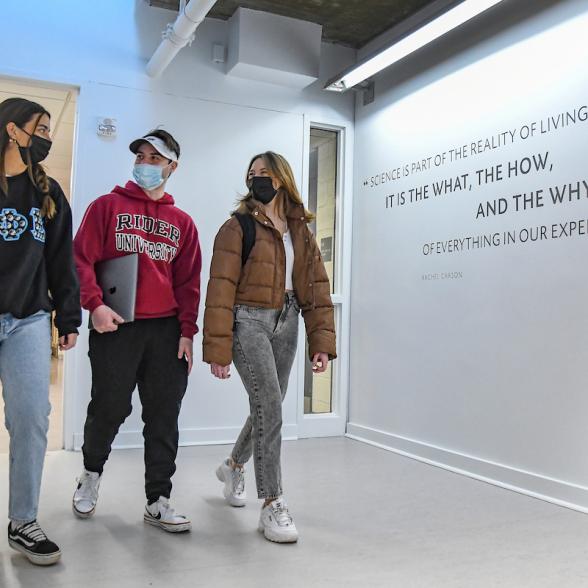 Students in masks walk through Hennessy Science and Technology Center