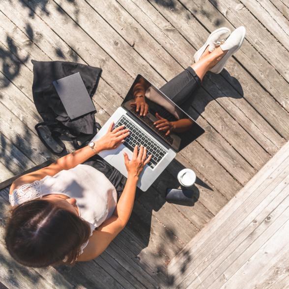 Woman on laptop outside