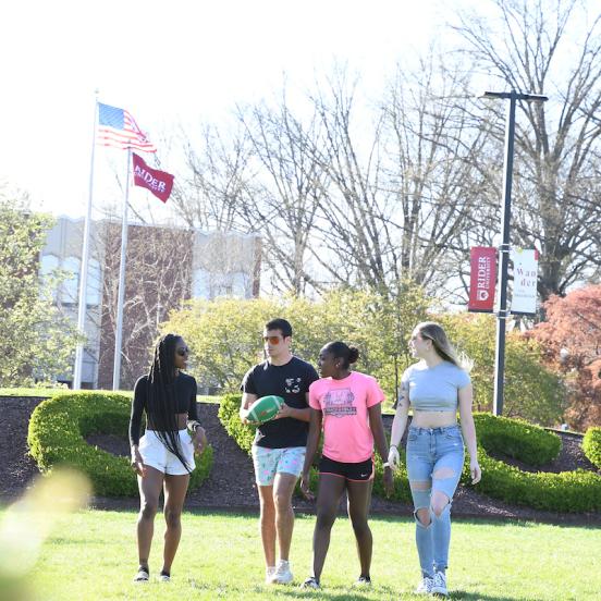 Students walk across the campus mall in summertime