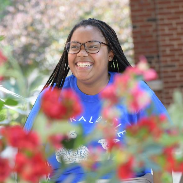 Student smiles on campus