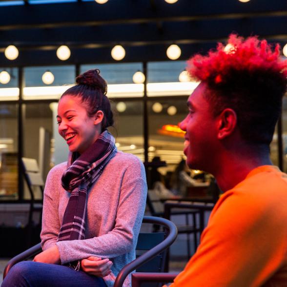 Students laugh together on BLC patio