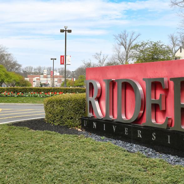 View of Main Entrance of campus with a cranberry sign that reads "Rider"