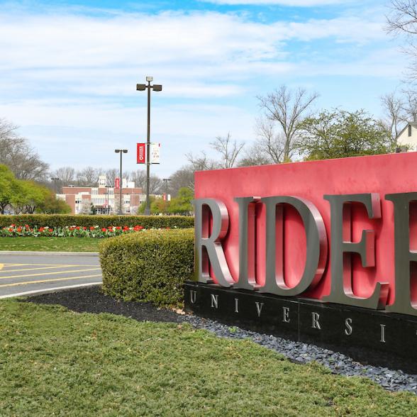 View of Main Entrance of campus with a cranberry sign that reads "Rider"