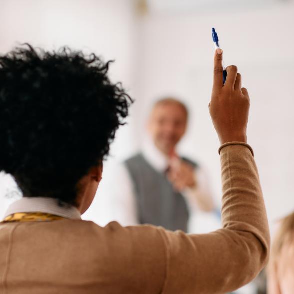 Student raising arm in classroom