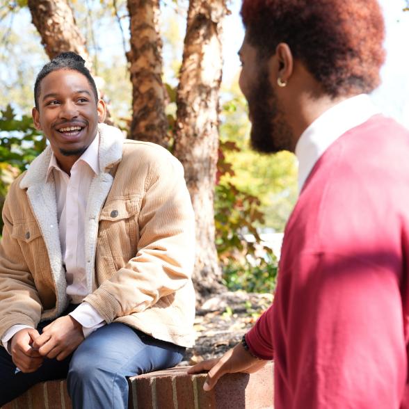 Students laughing together outside on campus