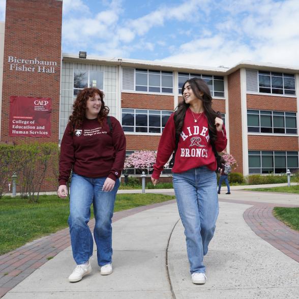 Students walking in front of Bierenbaum Fisher Hall