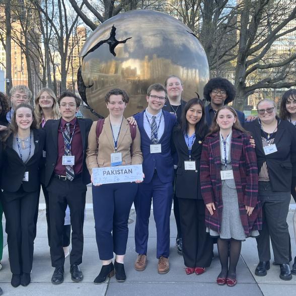 Model UN Students posing with sign