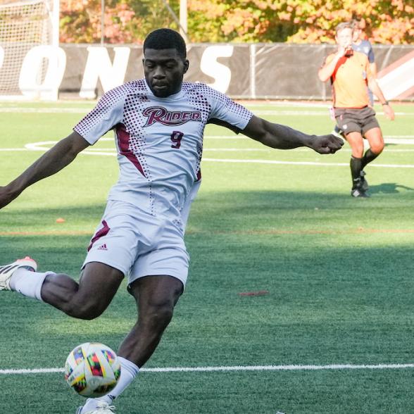 MSOC player striking ball during game