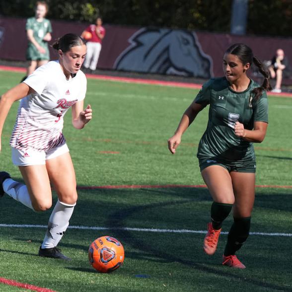 WSOC player dribbling ball