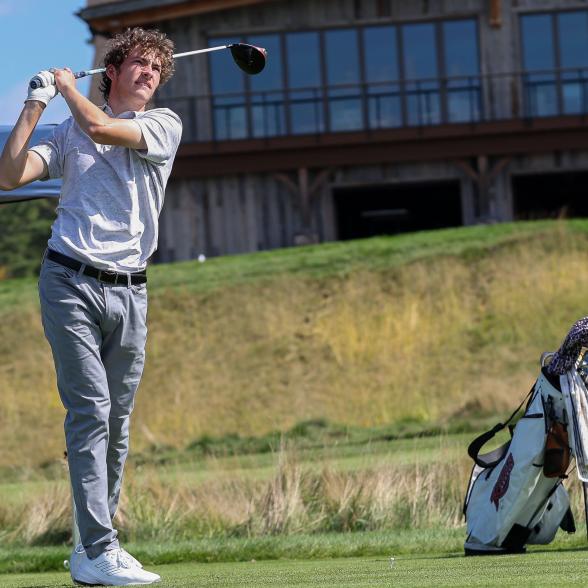 Men's golf player teeing off