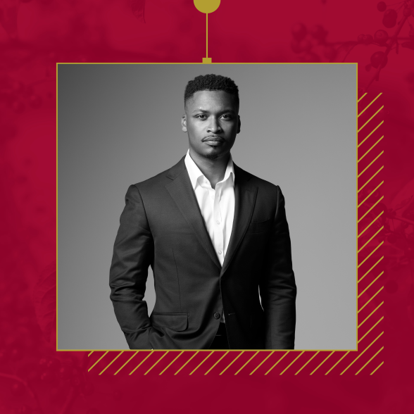 Dr. Tyrone Clinton in black and white photograph. He's wearing a sport jacket and white shirt. His right hand is in his pocket. The photo is black and white. 