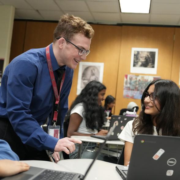 Teacher helps a student 