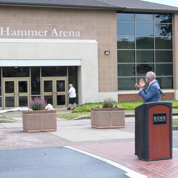 President John R Loyack applauds in front of Canastra Hammer Arena