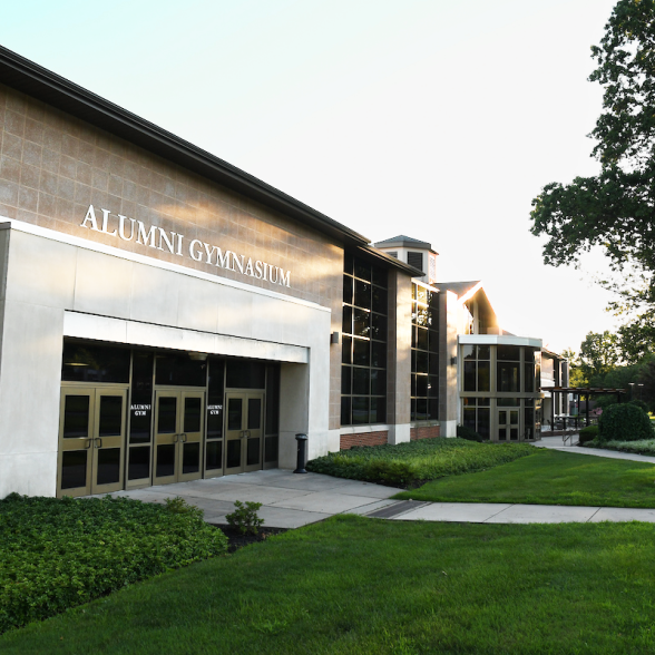 The outside of Alumni Gymnasium on a sunny day