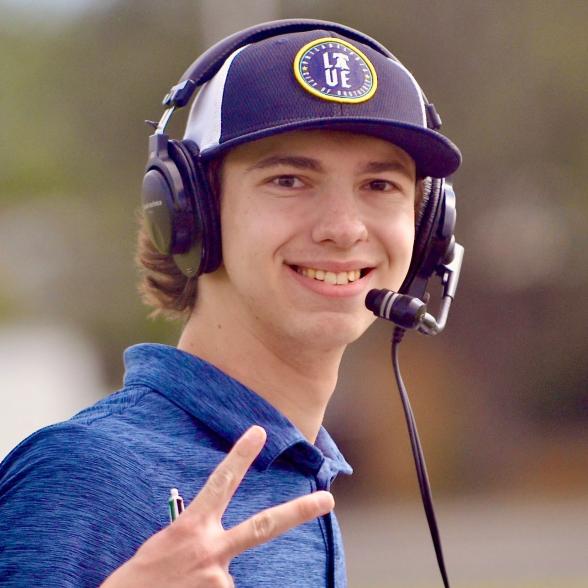 Jordan Hirsh makes a peace sign while broadcasting