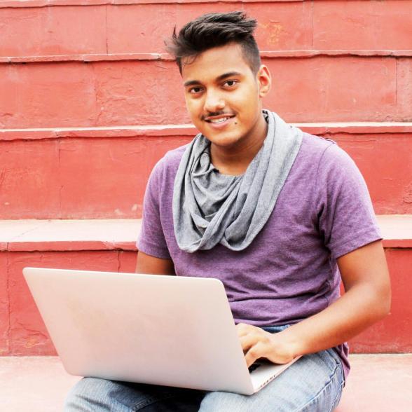Young man sitting with his laptop