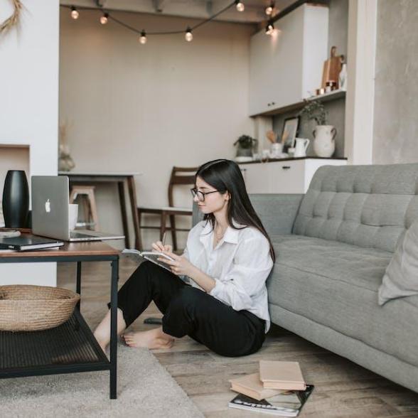 Woman sitting on floor looking at computer