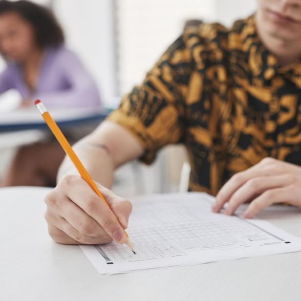 Person writing on a test