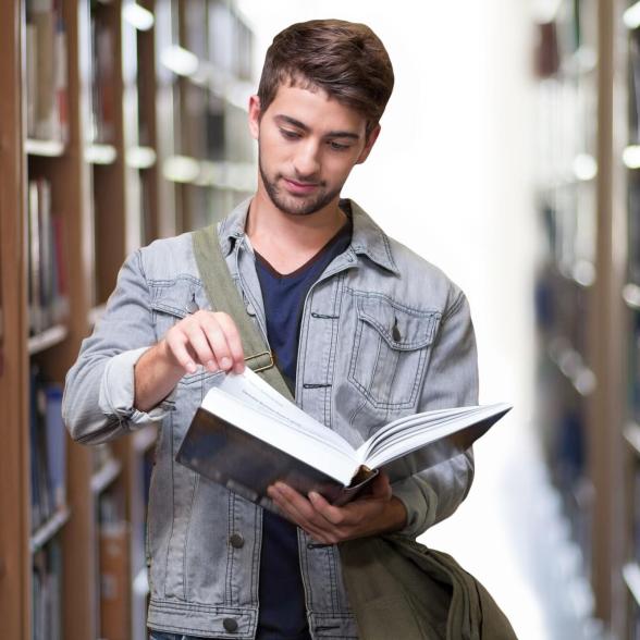 Young man looking at book