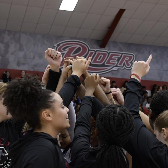 Women's basketball team gathers on the court