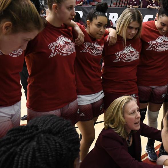 Rider's women's basketball team in a huddle