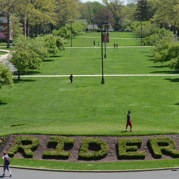 Students walk across the Rider Campus green
