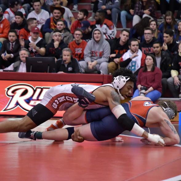 Wrestlers wrestle at Rider game.