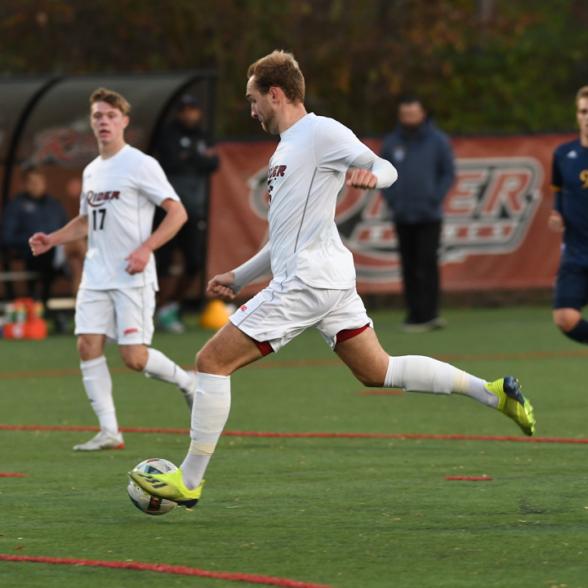 Soccer player kicks soccer ball.