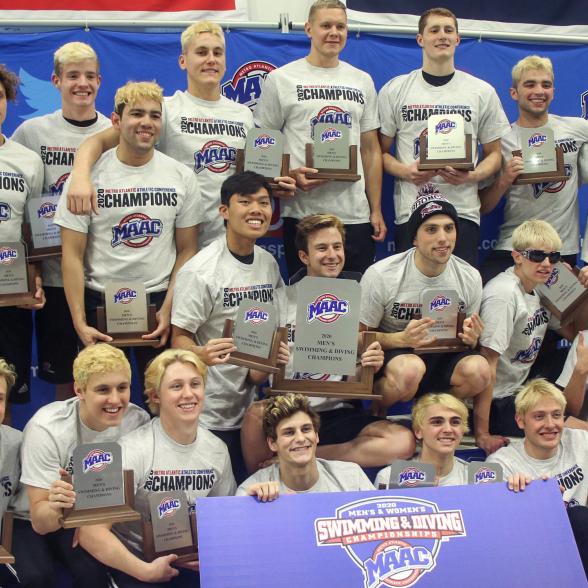 Men's swimming and diving team celebrates after winning its 