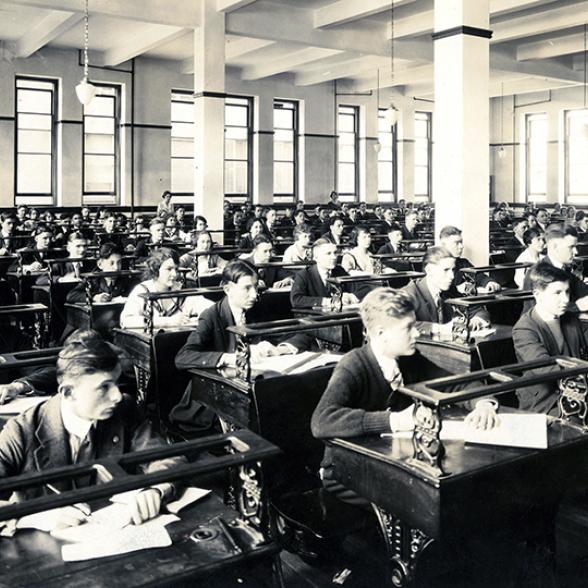 Male_and_female_students_seated_at_desks_in_classroom.jpg