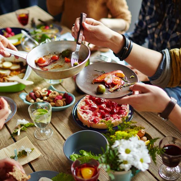 People gather around a table to eat a meal