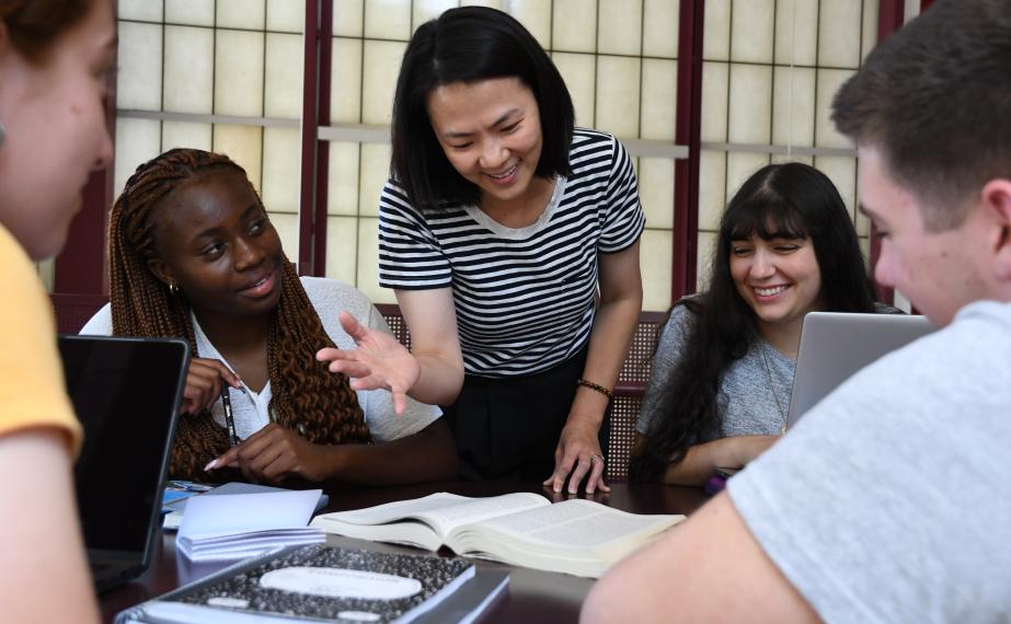 A student and professor at a table.