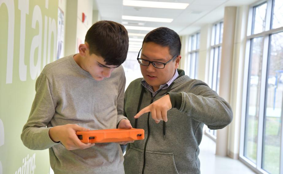 A teacher helping a student with special needs.