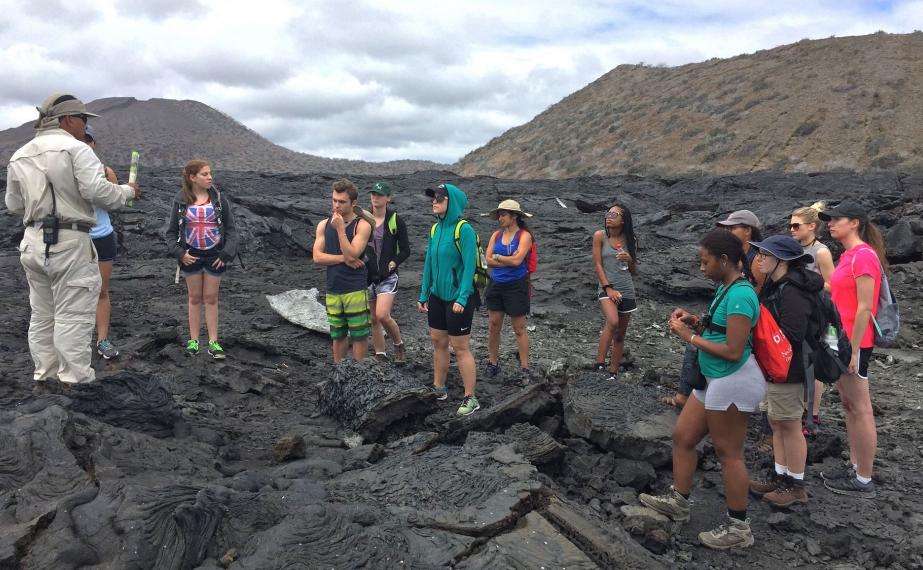 Students standing on volcanic ash in the galapagos