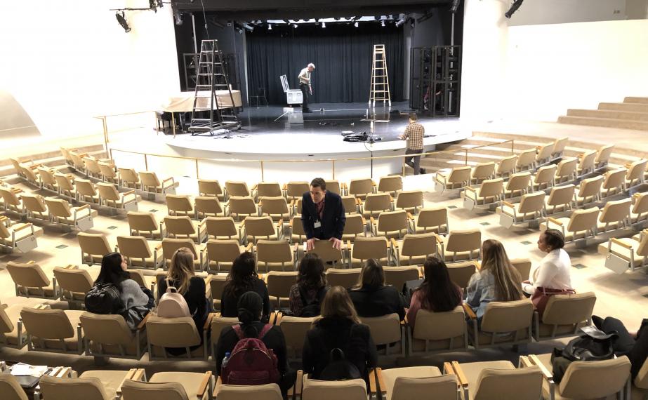 Photo of Arts administrator talking to a company in a theatre