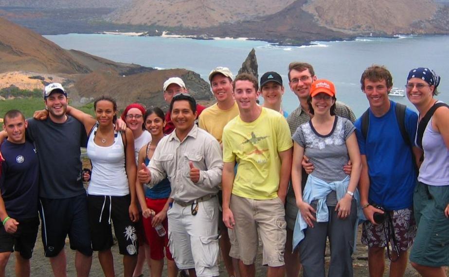 Group of students and faculty with a tour guide overlooking an oceanscape
