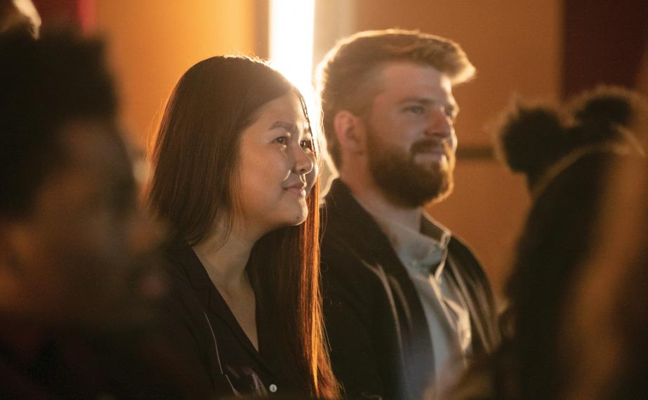 Students smile while listening to lecture