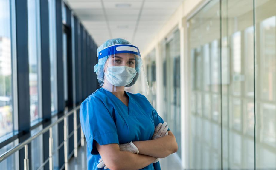 Nurse wears face shield and scrubs