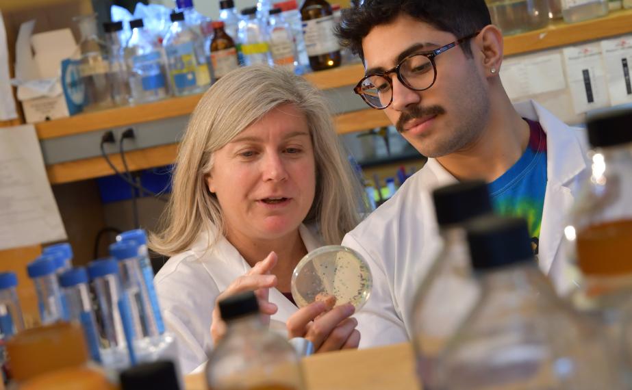 Professor and student converse in science lab