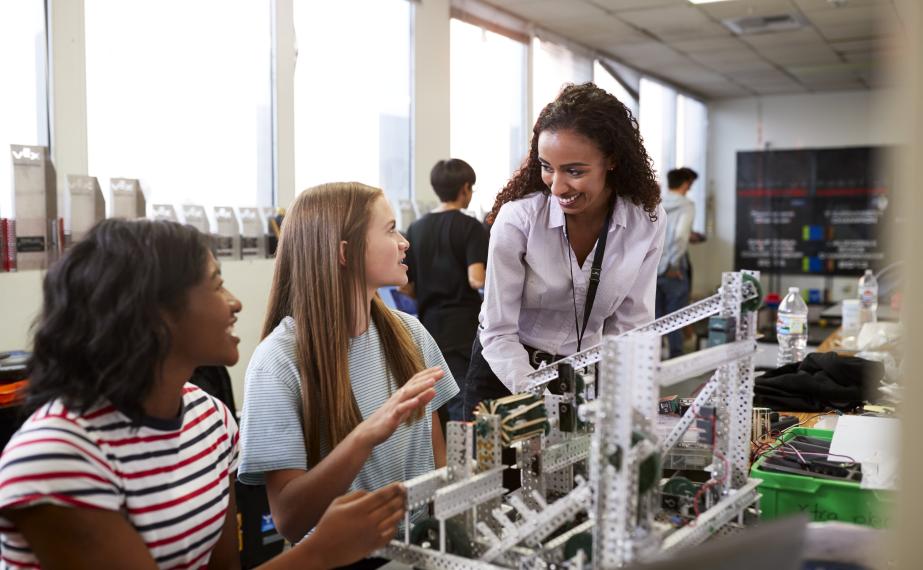 STEM teacher with students in a classroom