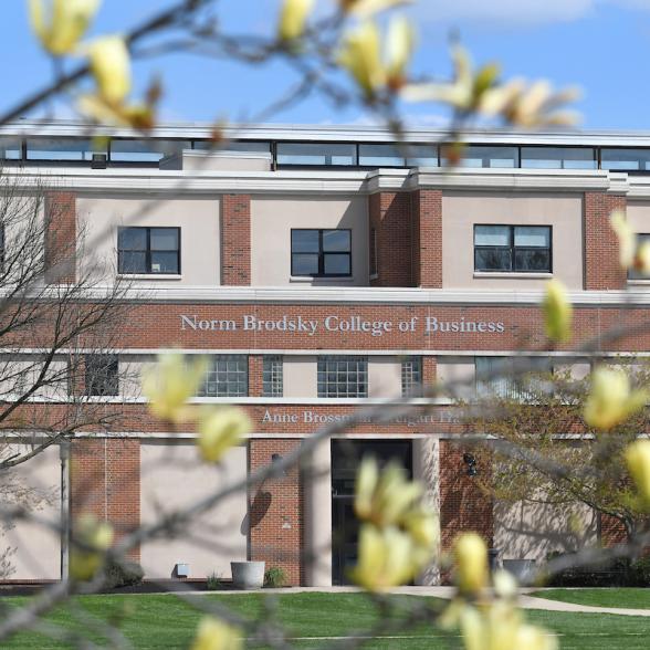 Norm Brodsky College of Business with flowers in the foreground