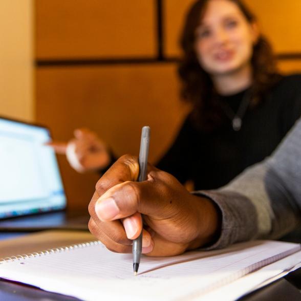 Two students working - close up on the hands