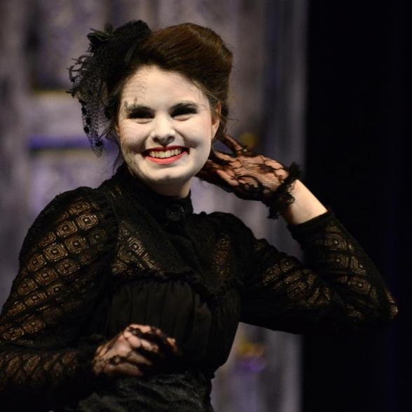 Female actress in gothic costume smiling at the camera